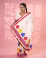 White Toss mekhela sador jura with colourful bindi buta, broad kalka phul lower-end design, and unstitched contrast pari