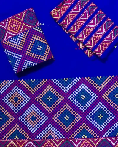 Blue Mising mekhela sador jura with colourful guti phul, Mising ghai phul, broad Mising pari, parboti work, and matching blouse piece