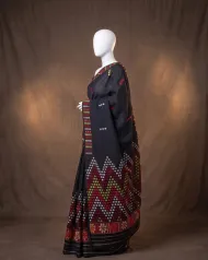 Black Mishing mekhela sador jura with blouse, self pari, and colourful Mising phul work