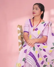 Light pink Kesa Paat Cotton mekhela sador set with purple, green, and yellow buta and dohi