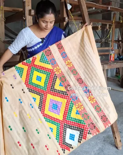 Golden Toss mekhela sador with blouse piece, colourful jora buta, Mising ghai phul, Mising pari, and tassel finish