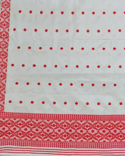 White Toss mekhela sador jura with red full body xoru phul buta, self pari, and red woven lower work