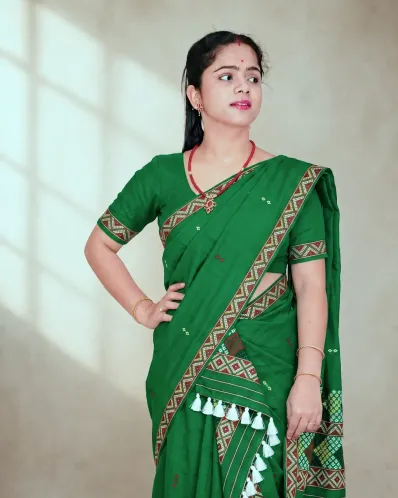 Green Mising mekhela sador with blouse piece, guti phul buta, Mising ghai phul, Mising pari, and white tassels