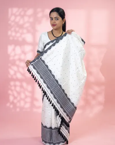 White Toss mekhela sador jura with black xoru buta, stitched black phulam pari, blouse piece, and stripe end