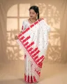 White Toss mekhela sador jura with red xoru phul buta, red modern phul, self pari, blouse piece, and white tassels