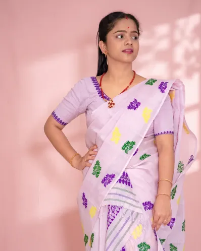 Light pink Kesa Paat Cotton mekhela sador set with purple, green, and yellow buta and dohi