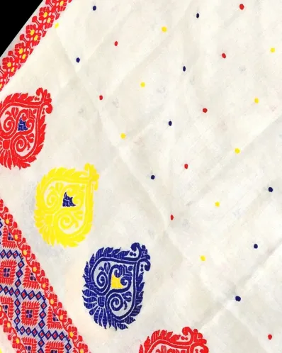 White Toss mekhela sador jura with colourful bindi buta, broad kalka phul lower-end design, and unstitched contrast pari