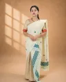 Natural beige ghisa cotton single sador with green and pink motifs, ghai phul, and dohi