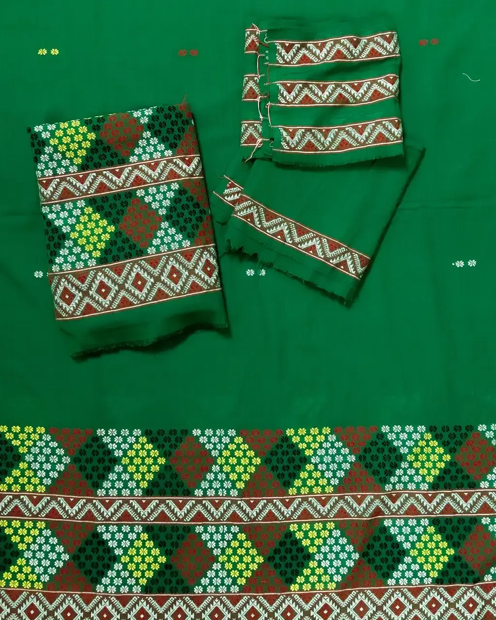 Green Mising mekhela sador with blouse piece, guti phul buta, Mising ghai phul, Mising pari, and white tassels