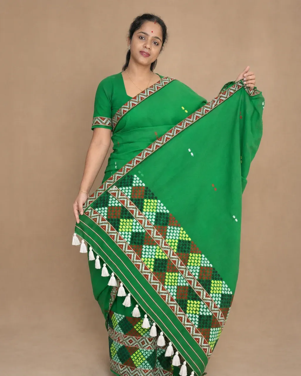Green Mising mekhela sador with blouse piece, guti phul buta, Mising ghai phul, Mising pari, and white tassels