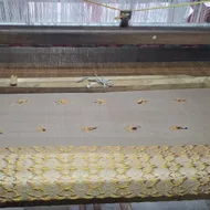 Handwoven fabric in production on a Taat Xaal
