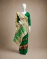 Woman wearing a pure natural golden Toss Riha Sador with green ful and whole body buta