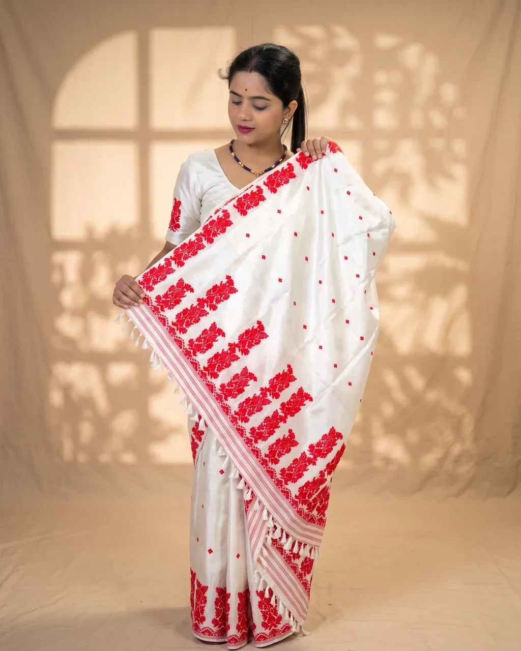 White Toss mekhela sador jura with red xoru phul buta, red modern phul, self pari, blouse piece, and white tassels